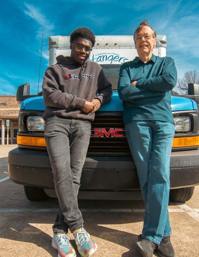 Two Men leaning on Donation Truck for Hangers of Hope Thrift Stores Benefiting the Bethesda Health Clinic in Tyler, TX