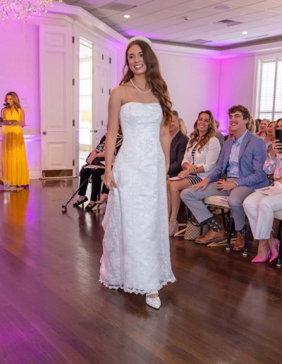 Woman in white dress at the Runway for Hope at Hangers of Hope Thrift Stores Benefiting the Bethesda Health Clinic in Tyler, TX