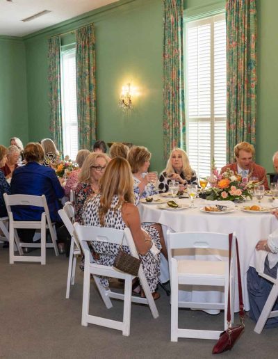 People eating at the Runway for Hope at Hangers of Hope Thrift Stores Benefiting the Bethesda Health Clinic in Tyler, TX