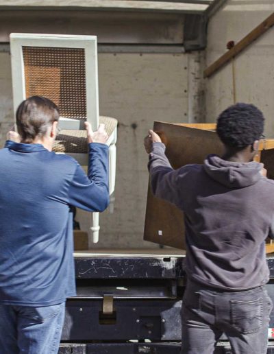 Two Employees Loading Chair and Table Donations into back of Donation Truck for Hangers of Hope Thrift Stores Benefiting the Bethesda Health Clinic in Tyler, TX